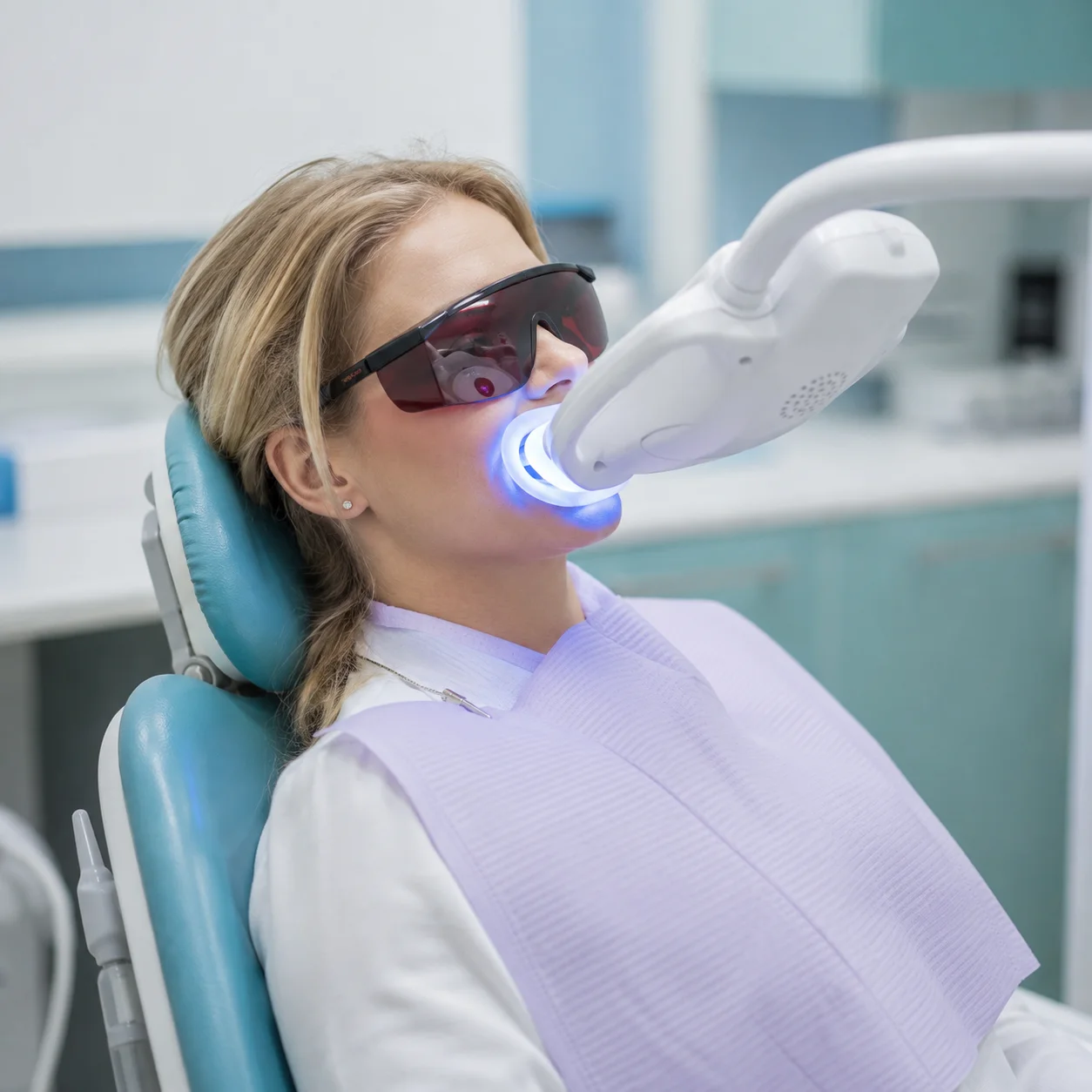 A patient receiving a whitening treatment at Halcyon Dental