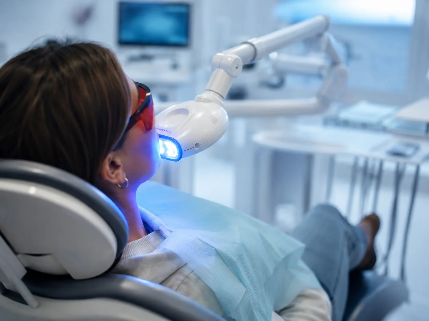 A patient receiving a whitening treatment at Alden Dental